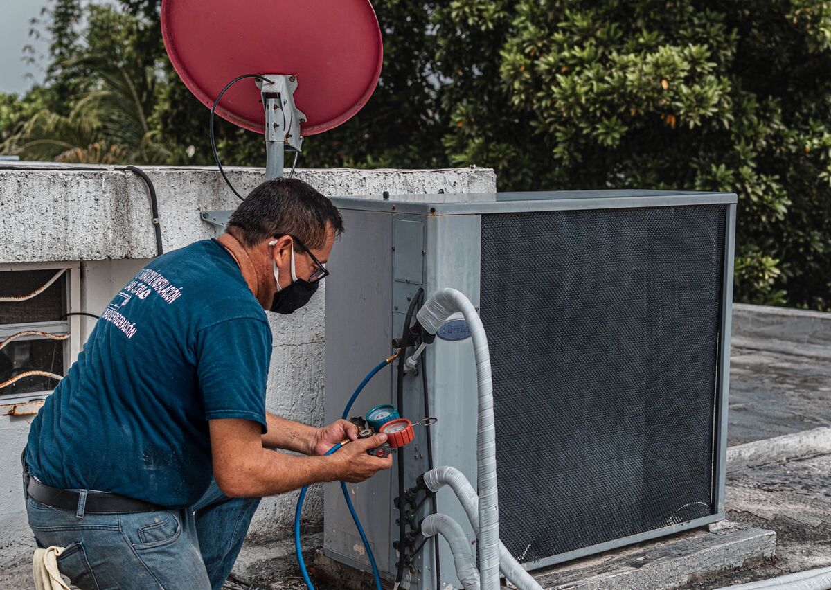 HVAC technician servicing an air-conditioning unit